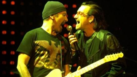 Image of a guitar player and singer with a microphone